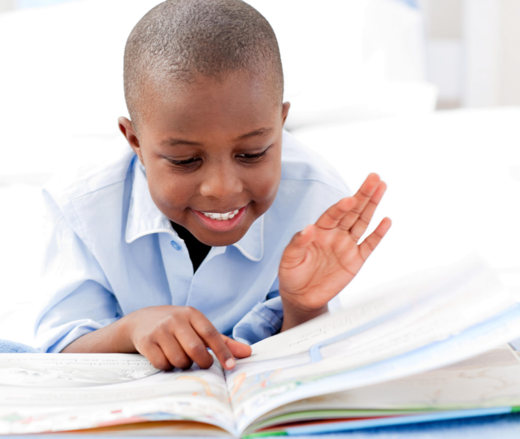 boy on floor reading a book