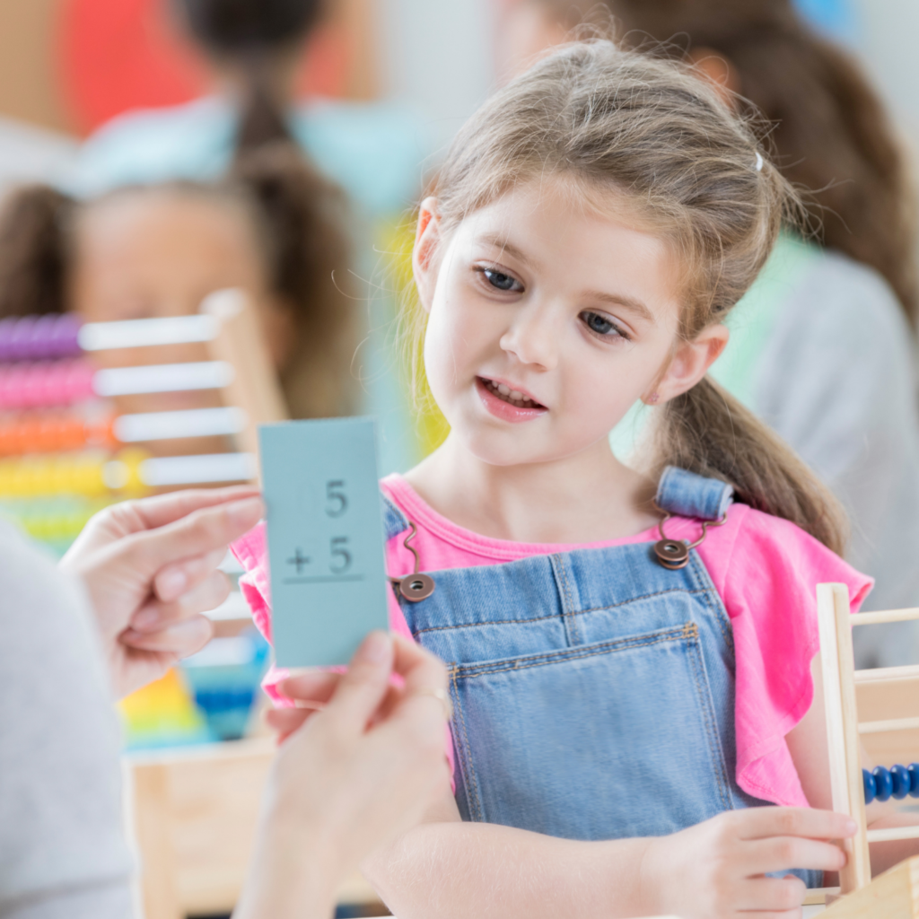 young students using task cards at math center