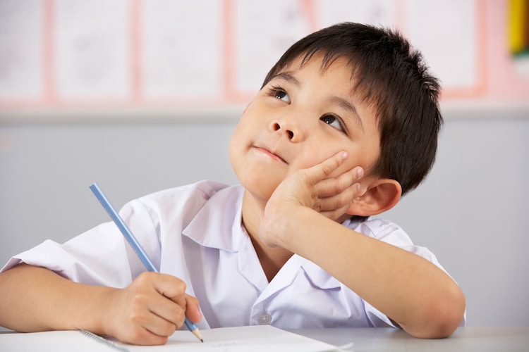 Image of small boy writing