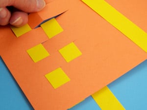 Image of orange and yellow weaved paper placemat
